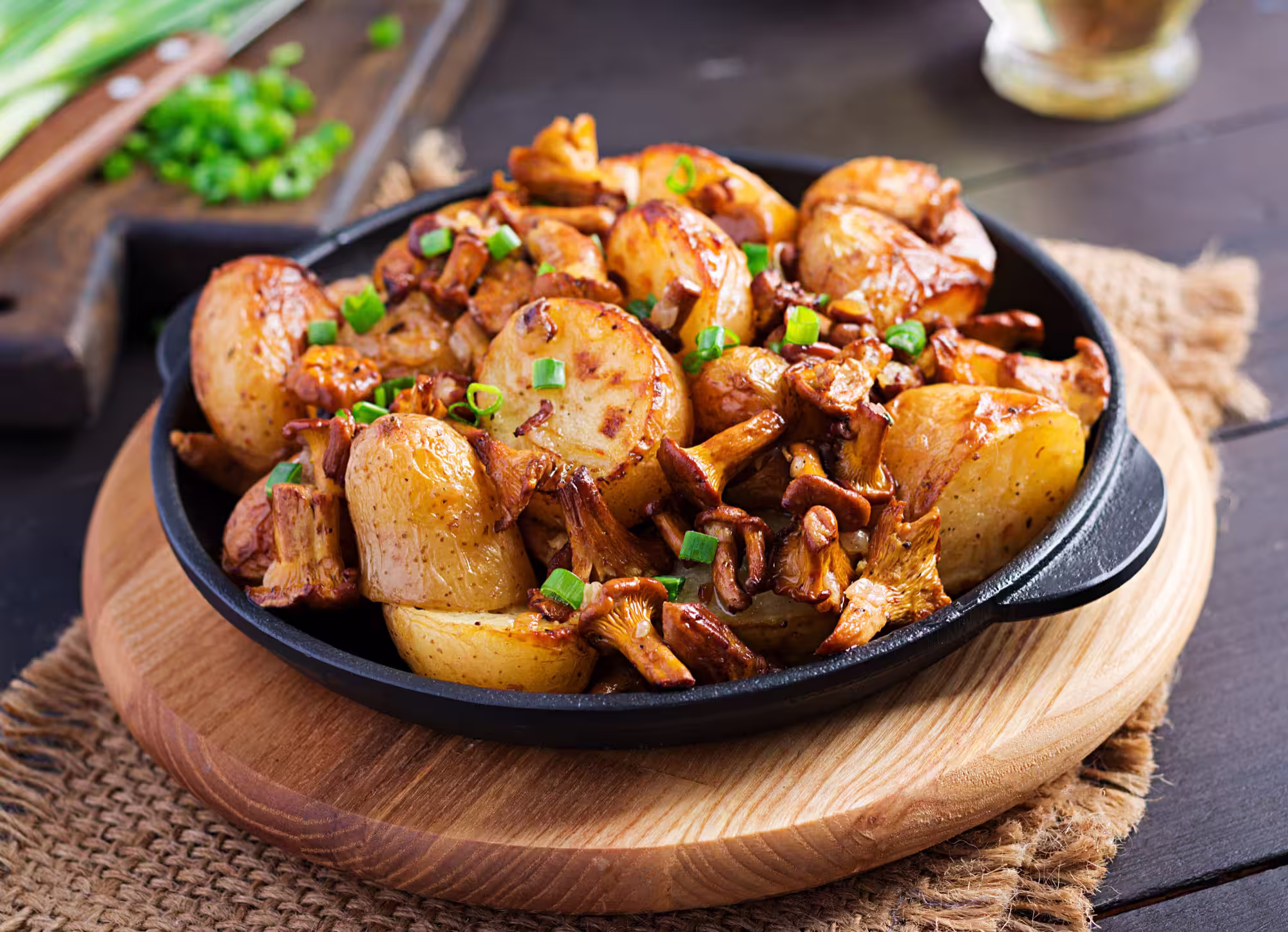 Baked potatoes topped with fried chanterelle mushrooms, garlic, and herbs
