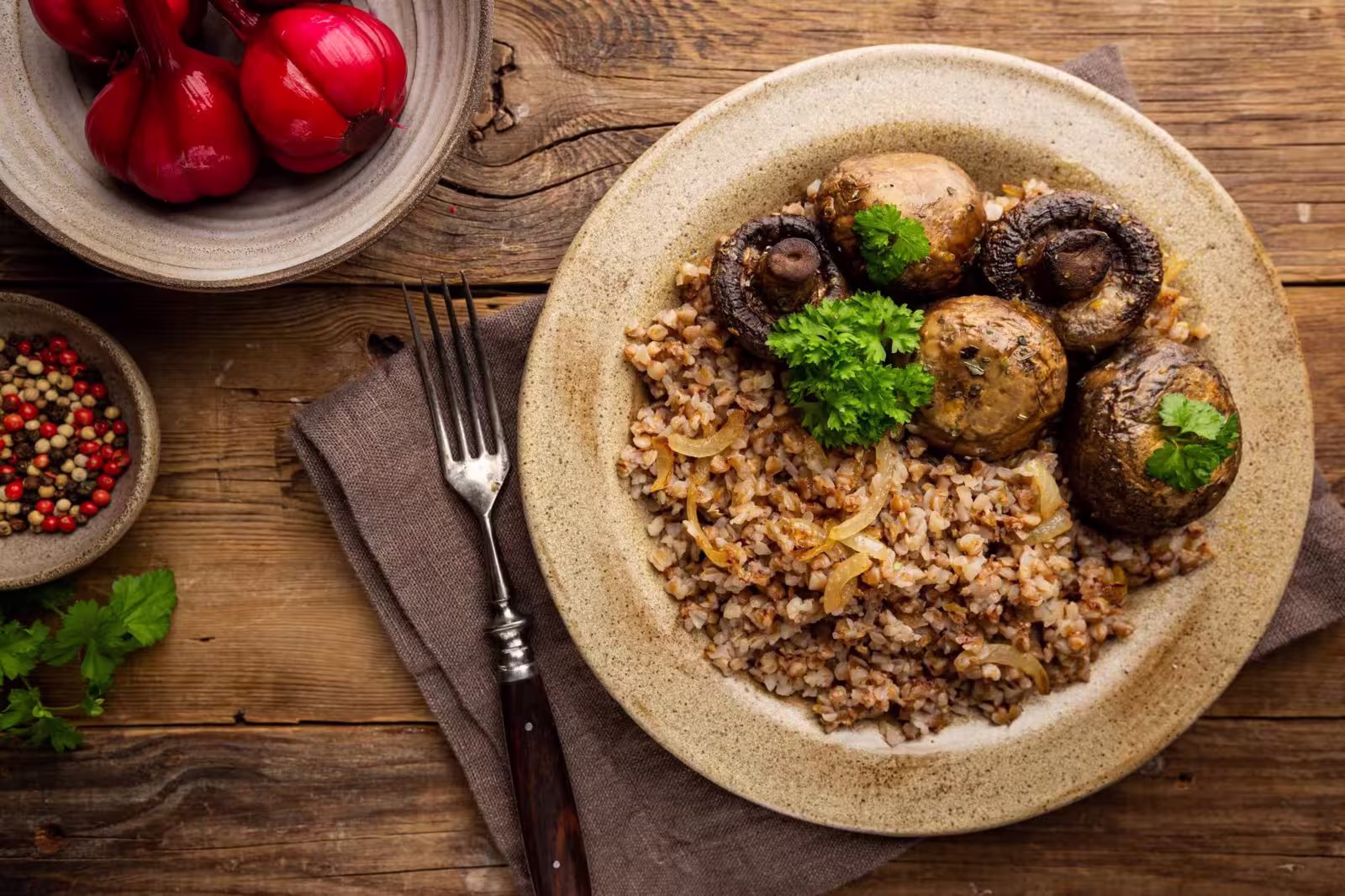 Bowl of buckwheat porridge topped with sautéed mushrooms