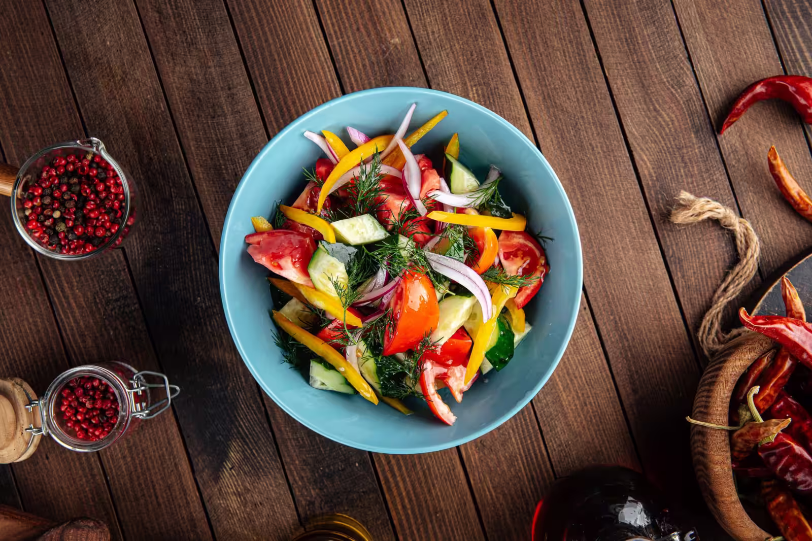 A colorful bowl of fresh garden vegetables salad mix topped with dill
