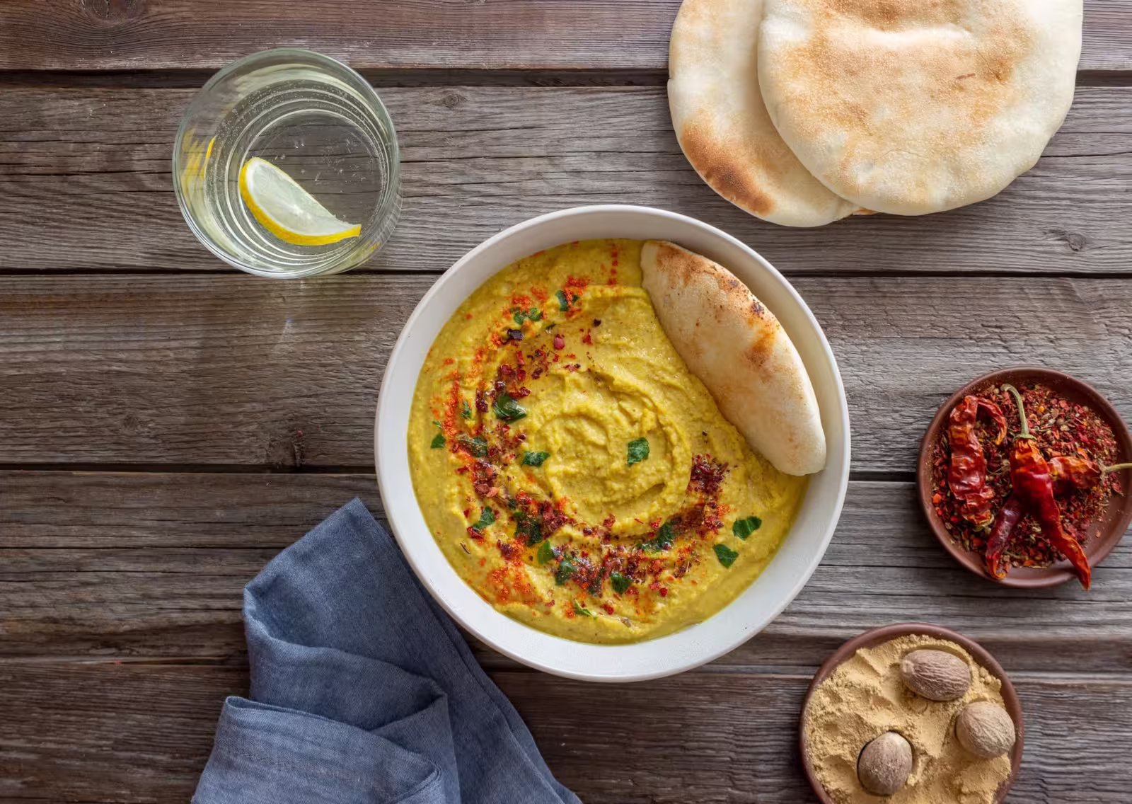 Creamy hummus garnished with chili flakes and nutmeg powder