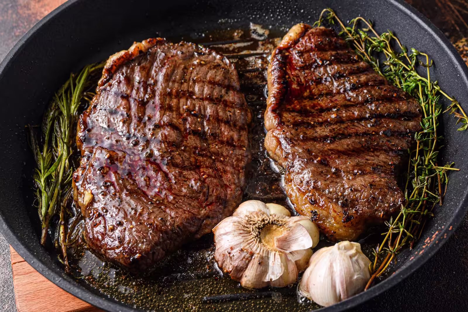 Pan-seared Picanha beef steaks sizzling in a skillet