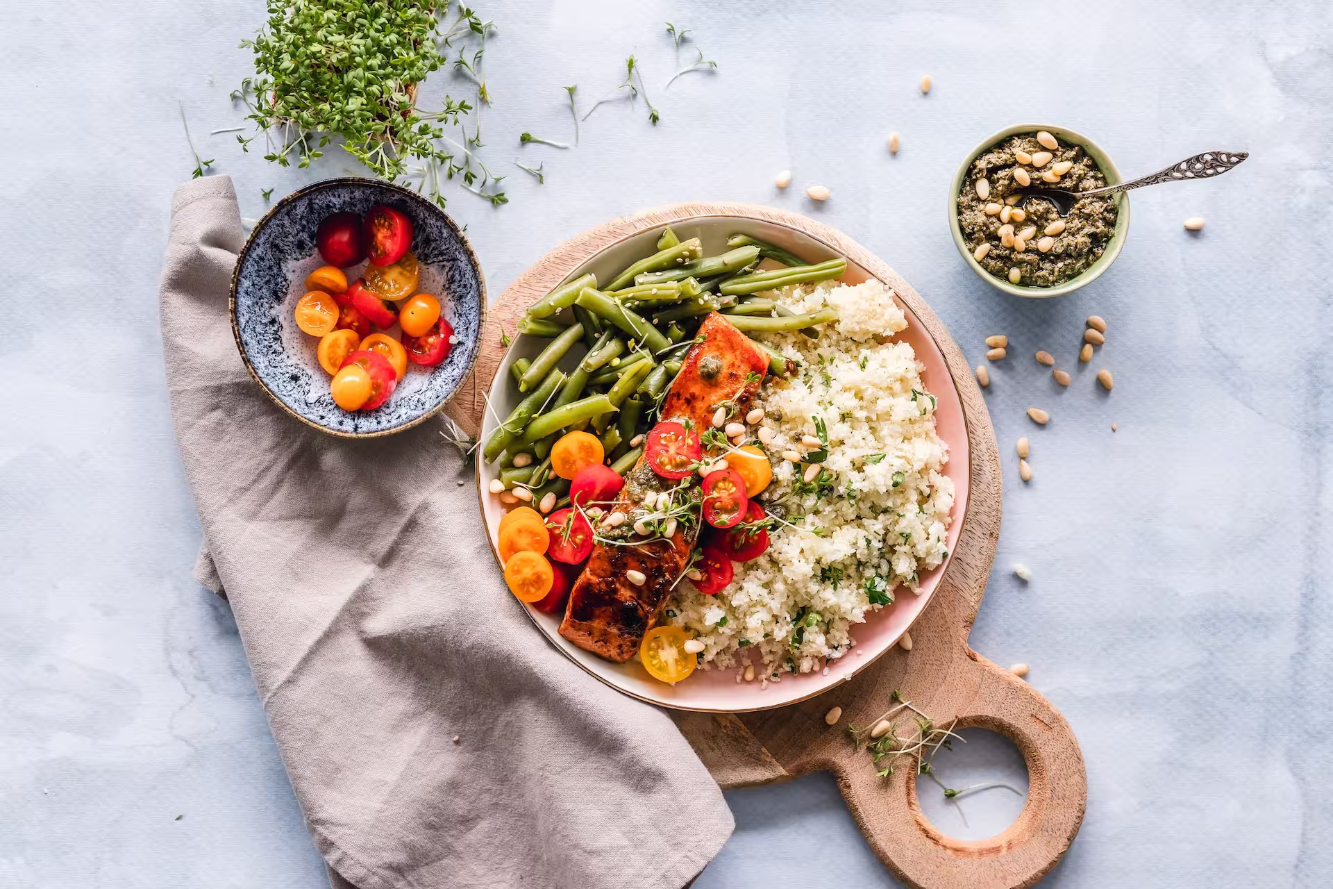 Plate of salmon and quinoa with cherry tomatoes and green lentils
